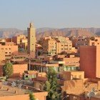 The sunrise illuminates the houses of Errachidia with warm tones, revealing Berber charm among quiet streets, traditional buildings, and desert landscapes.