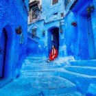 The blue medina of Chefchaouen envelops visitors with its sky-blue painted alleys, creating a peaceful atmosphere and colors that tell stories of history, spirituality, and local art.