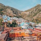 Chefchaouen opens up among the mountains with its bright blue houses blending into the landscape, offering a breathtaking view of nature and Moroccan tradition.