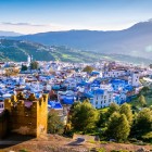 Chefchaouen viewed from above reveals a mosaic of turquoise houses nestled among the mountains, a unique village that enchants with its colors and the magical atmosphere of Morocco.