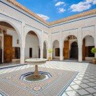 In the heart of the riad, the courtyard of Dar Si Said welcomes with carved columns, marble fountains, and the scent of cedar, embodying the elegance of Moroccan art.