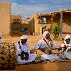 In Khamlia, Gnawa musicians play drums and traditional instruments, creating unique atmospheres in the heart of the Erg Chebbi desert.