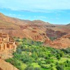 In the Ounila Valley, red-earth houses alternate with lush palm groves, creating a traditional Berber landscape set among valleys and hills.