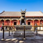 The Hall of Benevolence and Longevity in the Summer Palace, with golden roofs, carved beams, and imperial Qing dynasty decorations.