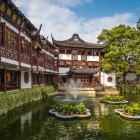The garden features elegant pavilions, arched bridges, and serene ponds, reflecting the harmony between nature and classical Chinese architecture.