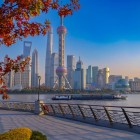 Panoramic view of Shanghai, where modern skyscrapers blend with historic architecture and the Huangpu River flows through the city.