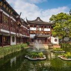 The garden features elegant pavilions, arched bridges, and serene ponds, reflecting the harmony between nature and classical Chinese architecture.