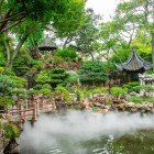 In the Yu Garden in Shanghai, rocks, plants, and pavilions blend harmoniously around ponds wrapped in a gentle, evocative mist.