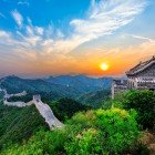 Panoramic view of the Great Wall of China across mountains and valleys, a majestic testament to military engineering and historic Chinese architecture.