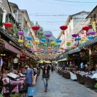 Colorful lanterns illuminate the restaurants of Yangshuo, along lively streets and traditional architecture, creating a unique and historic ambiance.
