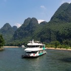 Cruise on the Li River in Guilin among karst mountains and picturesque villages, with views reflecting the history and nature of the region.