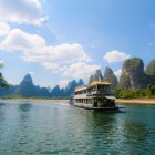 Cruise on the Li River in Guilin, among karst mountains and traditional villages. The river, known as "Guishui" in ancient times, has significant historical importance.