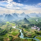 Aerial view of Guilin’s karst mountains and the Li River, with calm waters reflecting the iconic peaks of southern China.