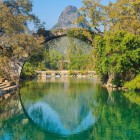 Fuli Bridge in Yangshuo crosses the river among karst mountains and traditional villages, a witness to local history and ancient Chinese architecture.