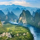 Panoramic view of Guilin’s karst mountains, with the unique peaks of southern China rising among vegetation and villages.