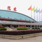 The exterior of Guilin International Airport showcases modern architecture amid green areas and spacious grounds, a strategic hub in southern China.