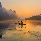 Traditional fishing boats on the Li River in Guilin, with bamboo rafts and trained cormorants, practice a fishing method dating back over 1,000 years.