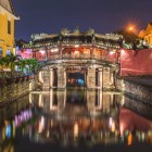 Built in the 17th century, Hoi An’s Japanese Covered Bridge shines at night, reflecting on the river and telling centuries of Chinese history and culture.