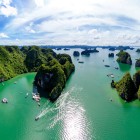 The view of the karst islands in Halong Bay shows spectacular rock formations rising from the emerald green waters, an iconic symbol of Vietnam.