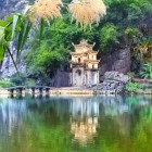 The entrance gate to the Bích Động Pagoda complex in Ninh Bình welcomes visitors with traditional Vietnamese architecture amid mountains and rice fields.