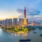 Aerial view of Saigon with the Ho Chi Minh Bridge, among modern skyscrapers, bustling traffic, and the vibrant heart of the Vietnamese city.