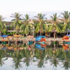 Hoi An’s river hosts local boats, creating picturesque views among ancient bridges, markets, and traditional houses of the historic town.