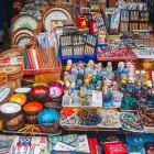 In Hoi An, stalls and shops offer Vietnamese souvenirs amid lanterns, fabrics, ceramics, and handcrafted items typical of the local culture.
