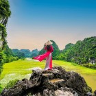 The rice fields in Tam Cốc stretch between rivers and karst mountains, creating spectacular green landscapes typical of rural Vietnam.