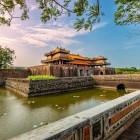 Hué’s Meridian Gate, connected by a historic bridge, enchants with monumental arches and architectural details of the Forbidden Citadel.