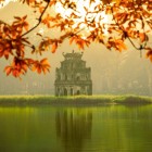 The Turtle Tower, situated on a small islet in the middle of Hoan Kiem Lake, is an elegant 19th-century monument symbolizing Hanoi and its legend.