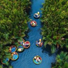 In Cam Thanh village, traditional bamboo boats glide through mangroves and canals, revealing the authentic river life of Vietnam.