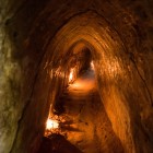 Inside the Cu Chi underground tunnels, narrow corridors, secret shelters, and Viet Cong traps demonstrate ingenuity and resilience.