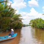 Excursion to Ben Tre among canals and orchards: a boat tour in the Mekong Delta among palm trees, markets, and small villages immersed in Vietnamese nature.