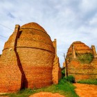 Brick kilns in the Mekong Delta showcase the ancient art of production, amid smoke, molded clay, and local Vietnamese traditions.