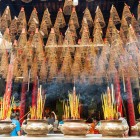 Inside Thien Hau Pagoda in Saigon, the scent of incense fills the air among Chinese statues and frescoes, creating a sacred and evocative atmosphere.