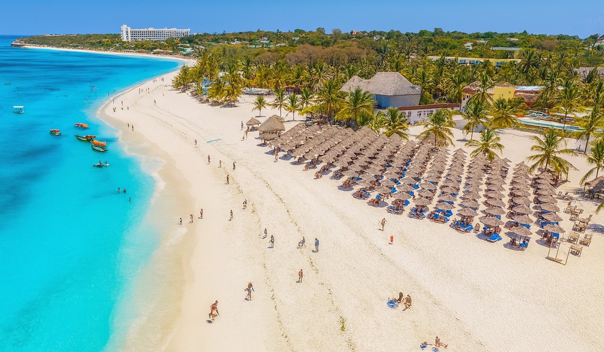 Kendwa Rocks Beach Hotel - The tropical-style property is surrounded by a palm-filled garden, with beachfront bungalows and a sandy pathway leading to the common areas.