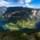 Breathtaking aerial view of the Sumidero Canyon in Chiapas, a majestic rocky gorge embracing an emerald river. One of the most spectacular and visited natural sites in Mexico.