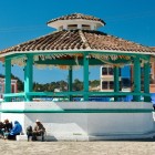 The Templo de San Juan Chamula overlooks the plaza with its central gazebo, surrounded by unique rituals and the lively presence of the Tzotzil locals, guardians of ancient Maya traditions.