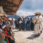 Mexican Indigenous people gather in the square wearing traditional Tzotzil clothing, colorful hats, vibrant ribbons and woolen garments, showcasing authentic local culture.