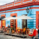 Local café on a typical street of the historic highland town, with vibrant colonial architecture and cobblestone streets in southern Mexico.