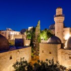 The rear view of the Shirvanshahs Palace in Baku reveals elegant domes, minarets and illuminated historic architecture, a symbol of Azerbaijan’s rich cultural heritage.
