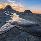 The mud volcanoes of Gobustan, near Baku, create spectacular landscapes with clay flows and grey formations: a unique and fascinating natural phenomenon of Azerbaijan.