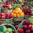 Baskets of fresh, colorful fruit at Yasil Bazar in Baku showcase local products and Azerbaijani culinary traditions in a lively atmosphere.