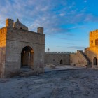 The interiors of the Absheron Fire Temple feature simple stone structures and sober spaces, with courtyards, arches, and areas dedicated to ancient fire worship, rich in historical and spiritual charm.