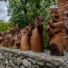 Terracotta sculptures depict traditional Azerbaijani figures in historic attire with instruments, expressing local culture and ancient traditions.
