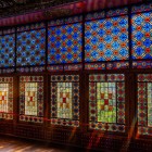 Colored glass mosaics with geometric and floral motifs create vivid light effects, a refined expression of traditional Azerbaijani art in the Khan’s Palace.