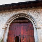 The wooden portal of the Sheki Caravanserai, with its decorated stone arch, reflects Silk Road architecture blending elegance and functionality.