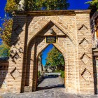 Brick entrance with a pointed arch decorated with geometric motifs, typical of Caucasian architecture, leading to the Sheki Khan’s Palace.