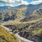Small villages dot the valley along the Georgian Military Road: green hills, winding rivers and the Caucasus mountains frame an authentic and evocative landscape.