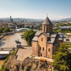 The Metekhi Church overlooks the Kura River from a rocky cliff: a symbol of Tbilisi, blending medieval history with spectacular city views.